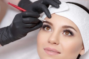 Woman getting a session of her Ombre Eyebrow Tattooing