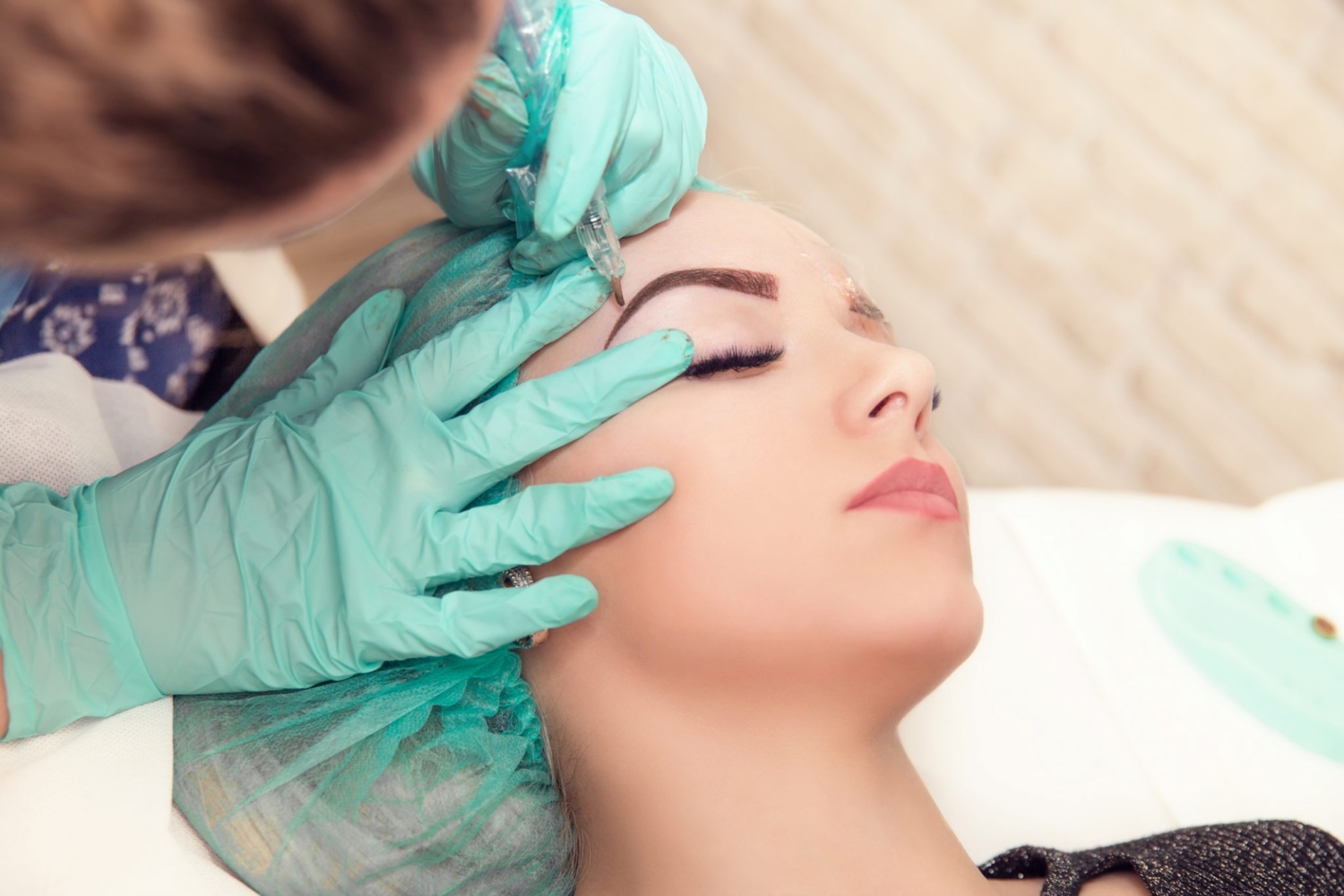 Brow Tattooist tattooing Eyebrows